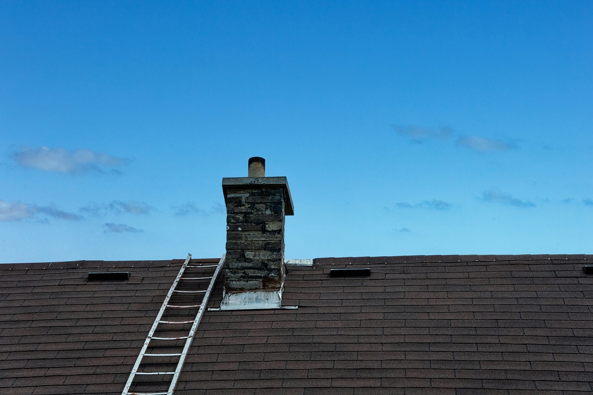 ladder on a roof leading to the chimney